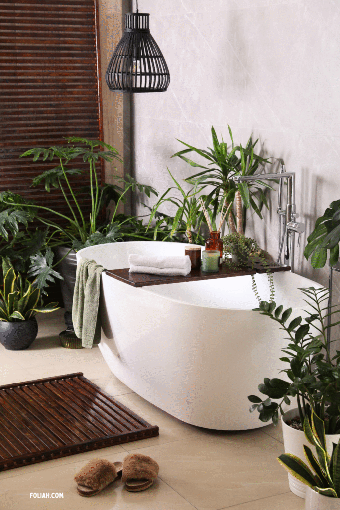 Modern bathroom with a white freestanding tub surrounded by snake plants, dracaena, philodendron, and trailing greenery, styled with a wooden bath board, candles, and natural accents for a calm, spa-like design.