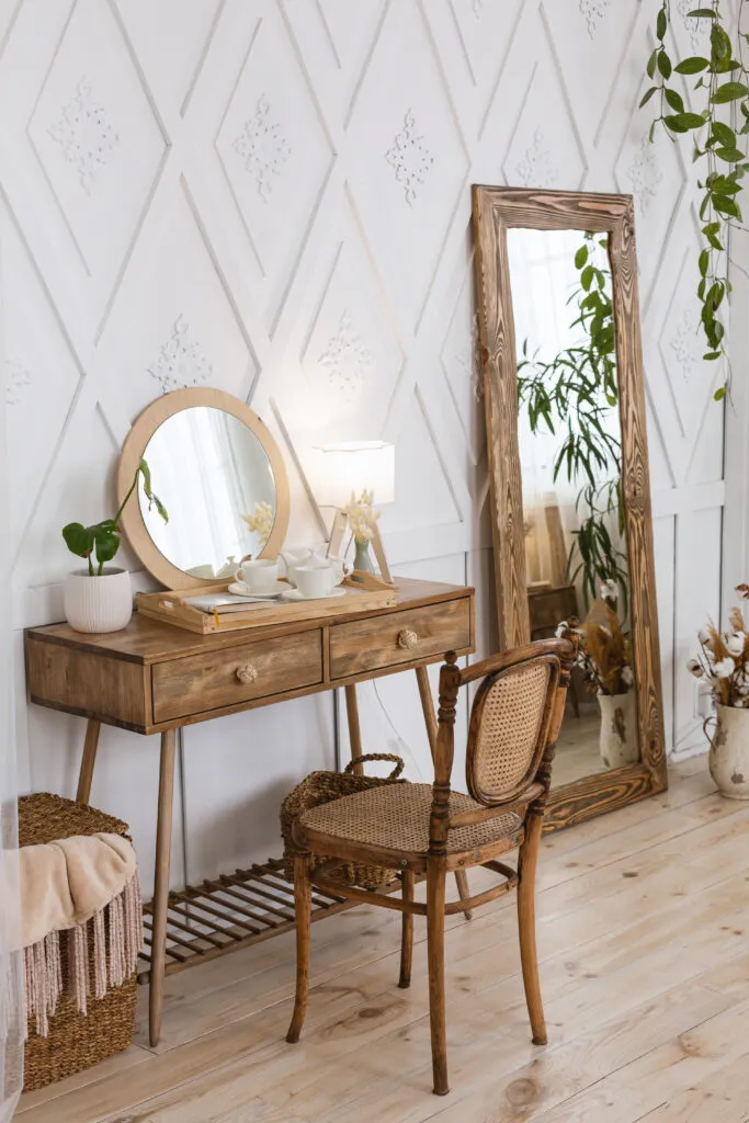 Bedroom vanity area with a mirror reflecting indoor plants, creating a brighter space with doubled greenery.