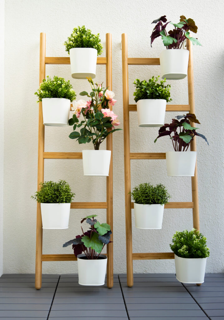 white pods  with green flowers on the decorative wooden plant wall in home interior